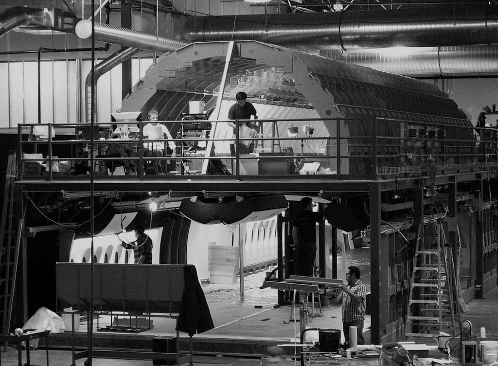 747 large scale prototype with three men working inside