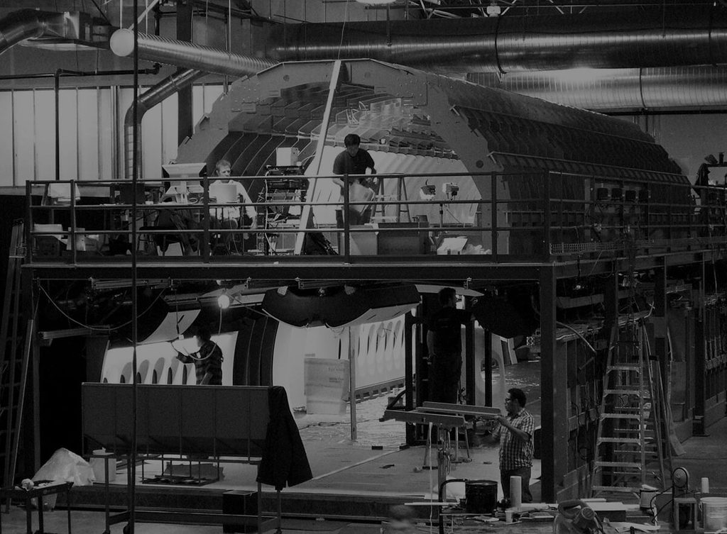 Three men working in full scale mockup of Boeing 747