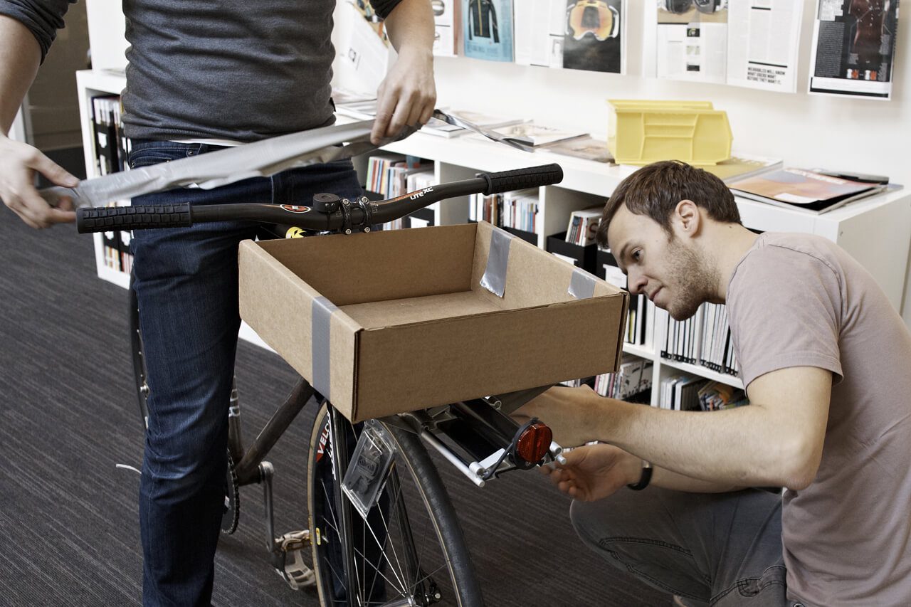 Two men prototyping Denny bike basket