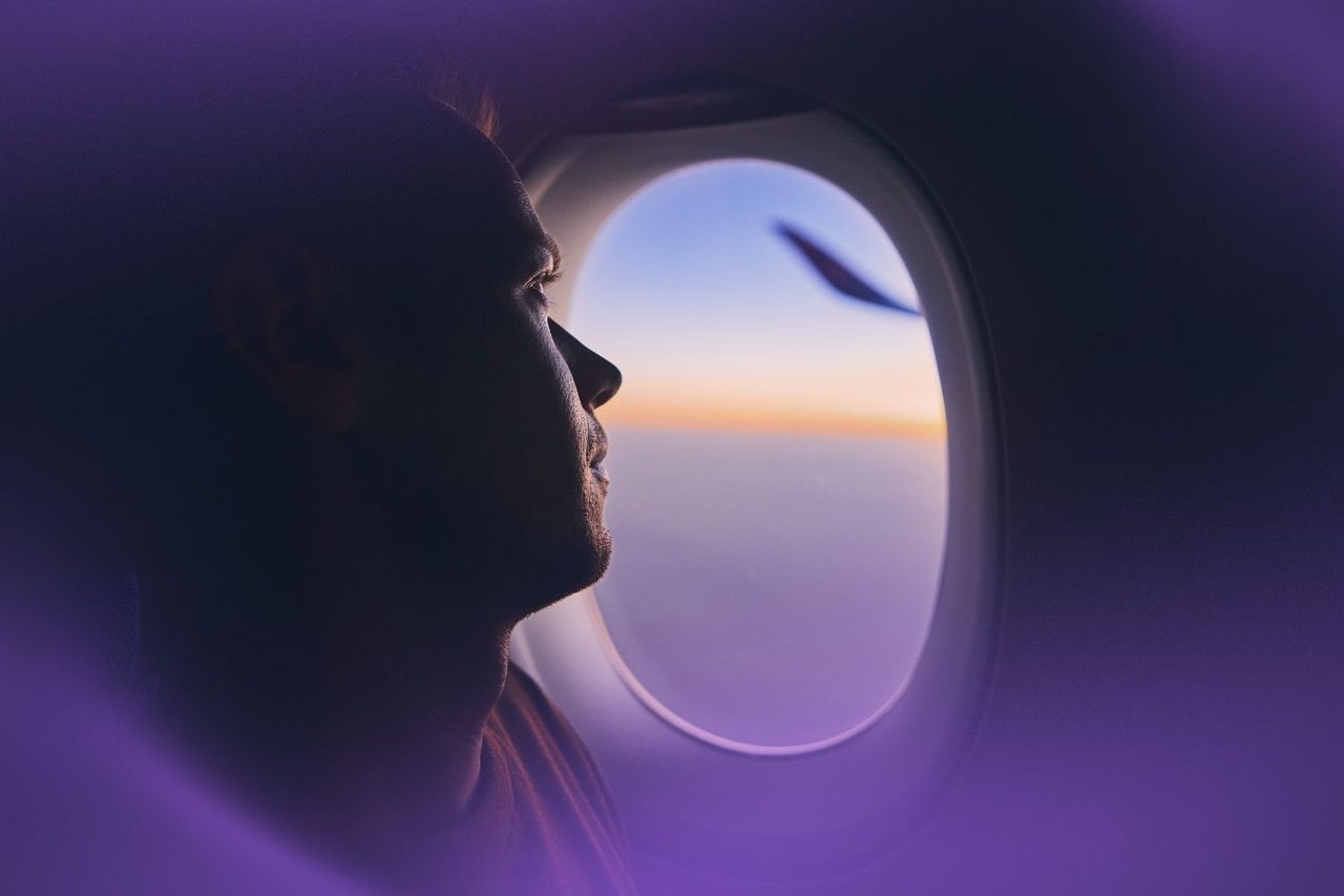 Man looking out airplane window