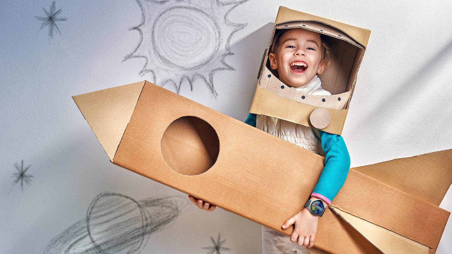 Girl wearing cardboard costume playing make believe