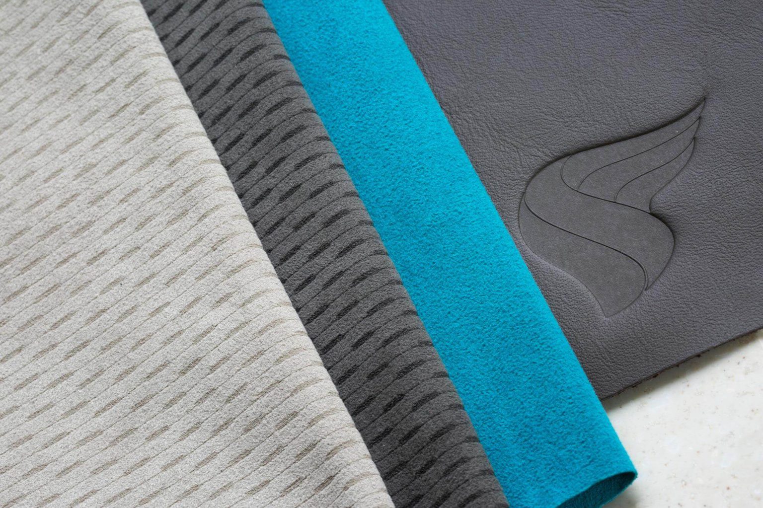 Oman Air fabric and material selection in beige, teal and dark brown with logo emboss