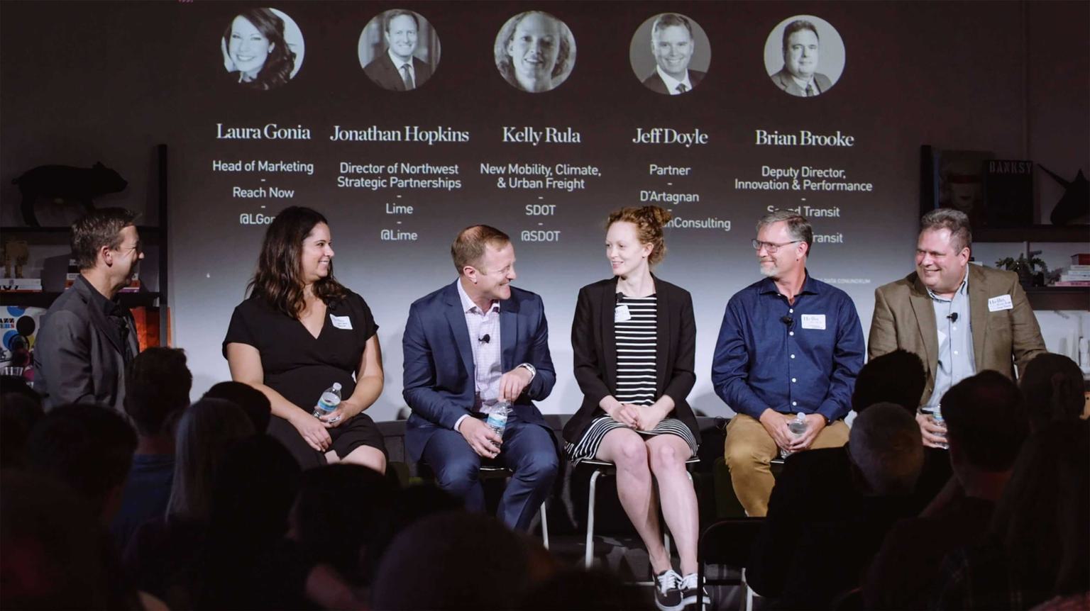 Speakers sitting on stage for a panel discussion