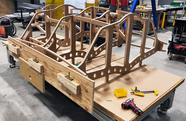 Wood framing for VTOL fighter jet model sitting in workshop