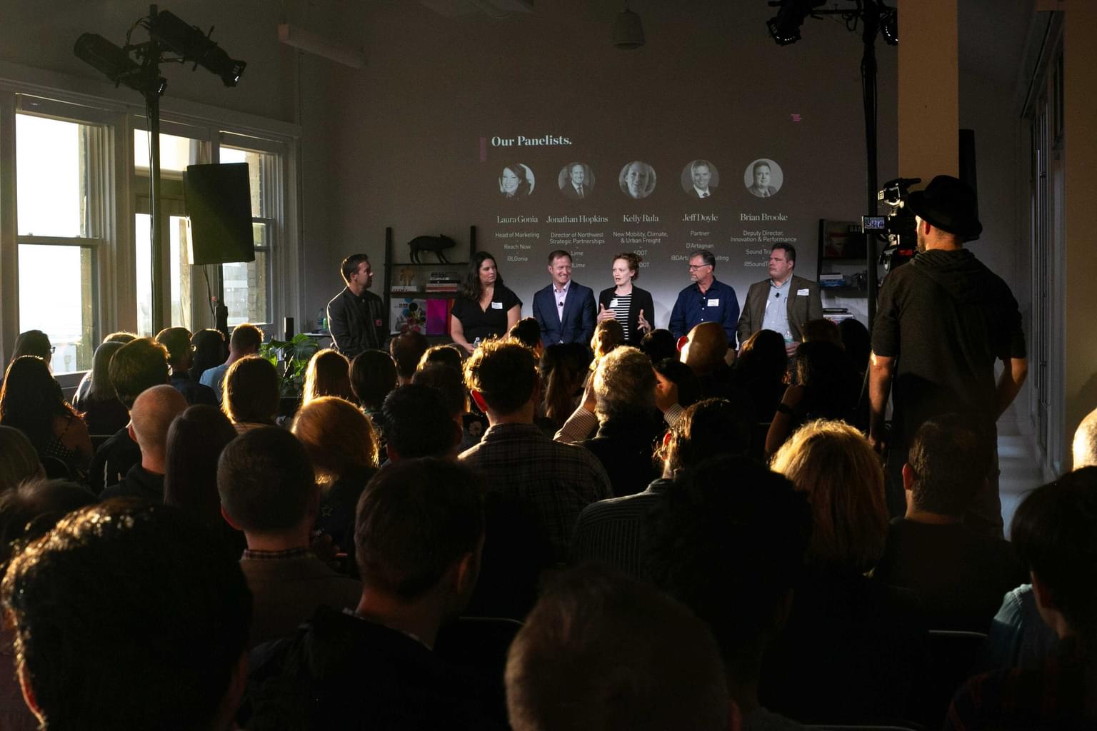 Audience watching a panel of speakers at an event