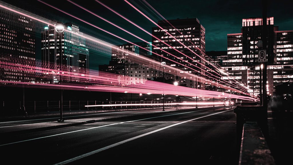 A city at night with cars speeding