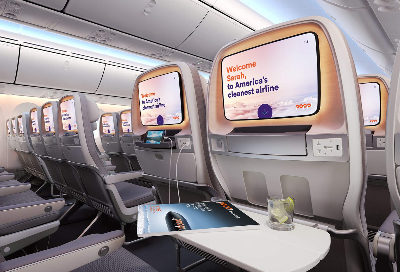 Airplane cabin with welcome message on seat back screen