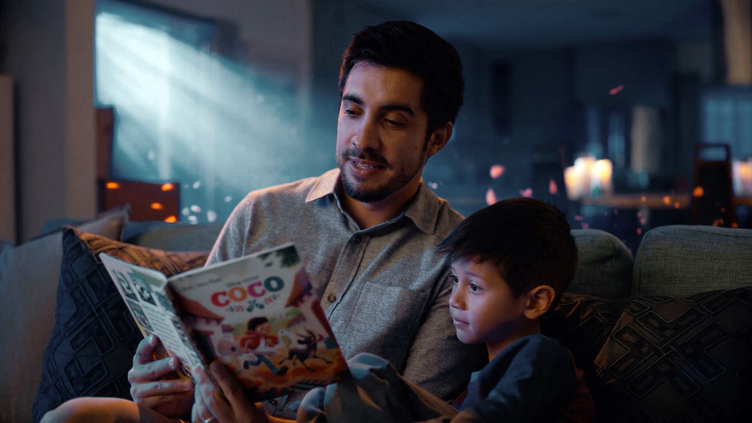 Man reading a book to a young boy