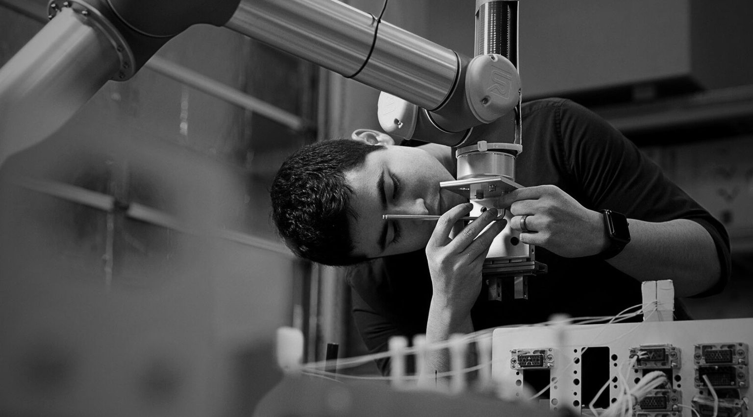 Man operating robot arm