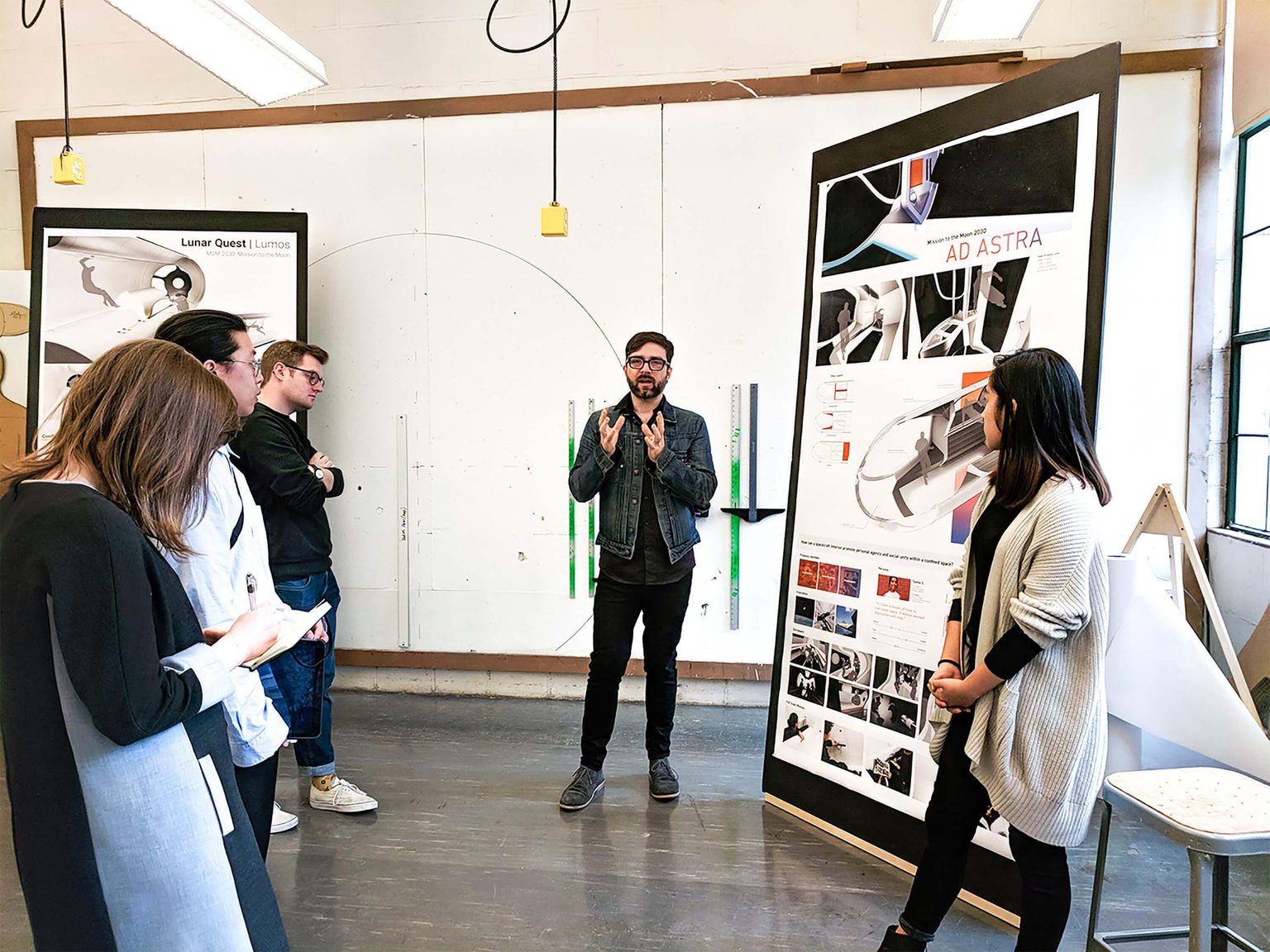 Group standing in a class room reviewing ideas on a whiteboard